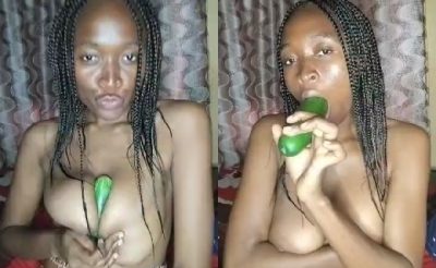 A hungry babe using a cucumber to play